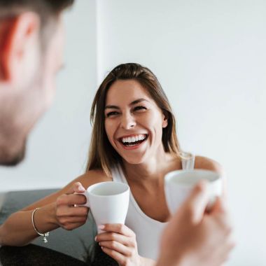 AdobeStock_208131995@bnenin_Laughing couple drinking coffee in the morning